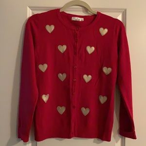 Red cardigan with gold hearts.